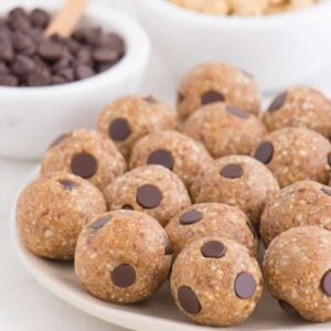 chocolate chip cookie dough balls sitting on a white plate