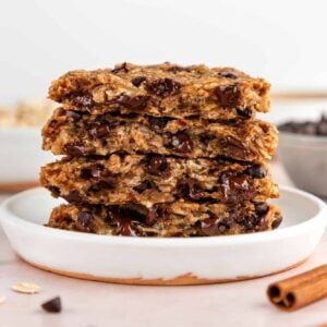 a stack of peanut butter banana oatmeal cookies with chocolate chips on a small white plate