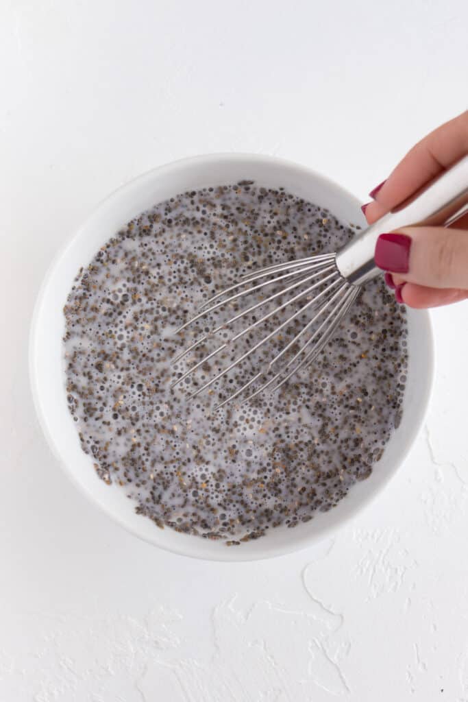 whisking chia seeds and almond milk in a bowl