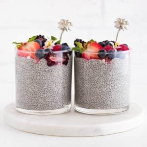 two cups of vanilla chia pudding topped with berries