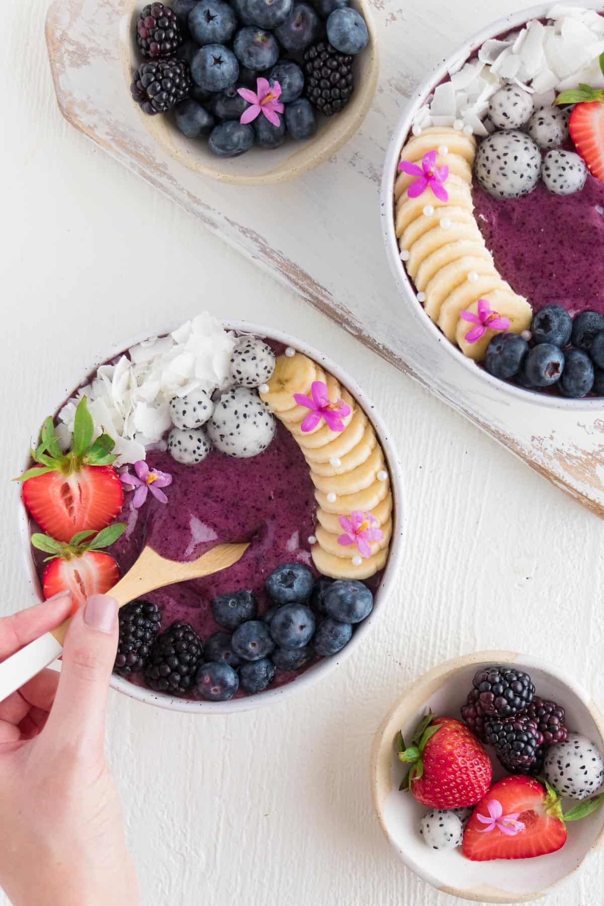 a spoon scooping into an acai bowl
