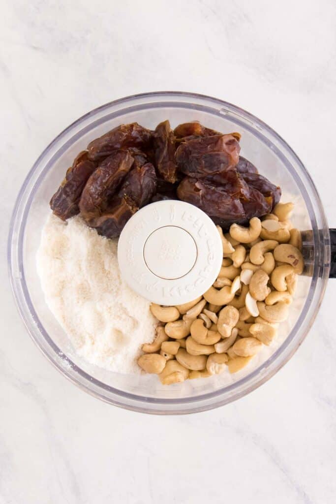 medjool dates, coconut flour, and cashews inside a food processor
