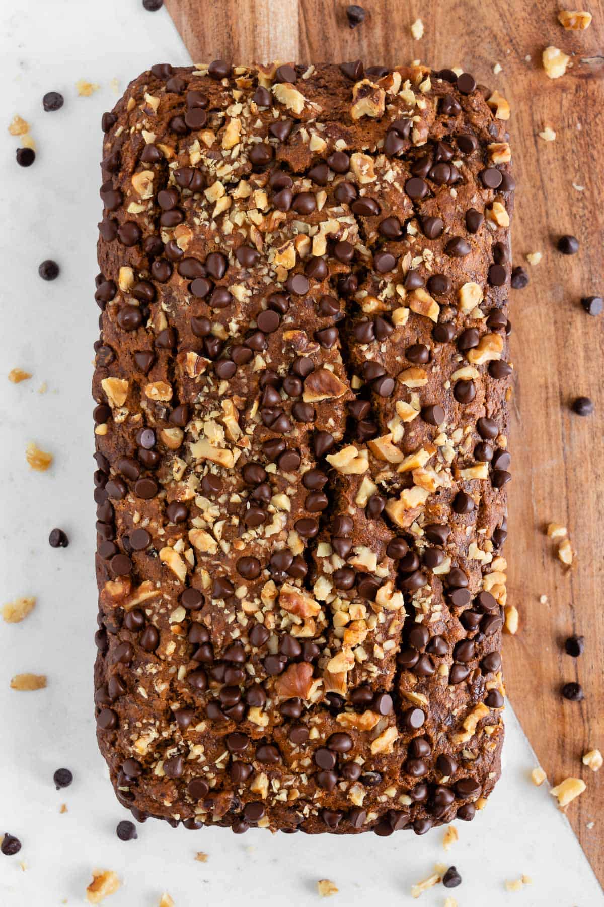 three slices of vegan gluten-free banana bread and a bowl of rolled oats, walnuts, and chocolate chips