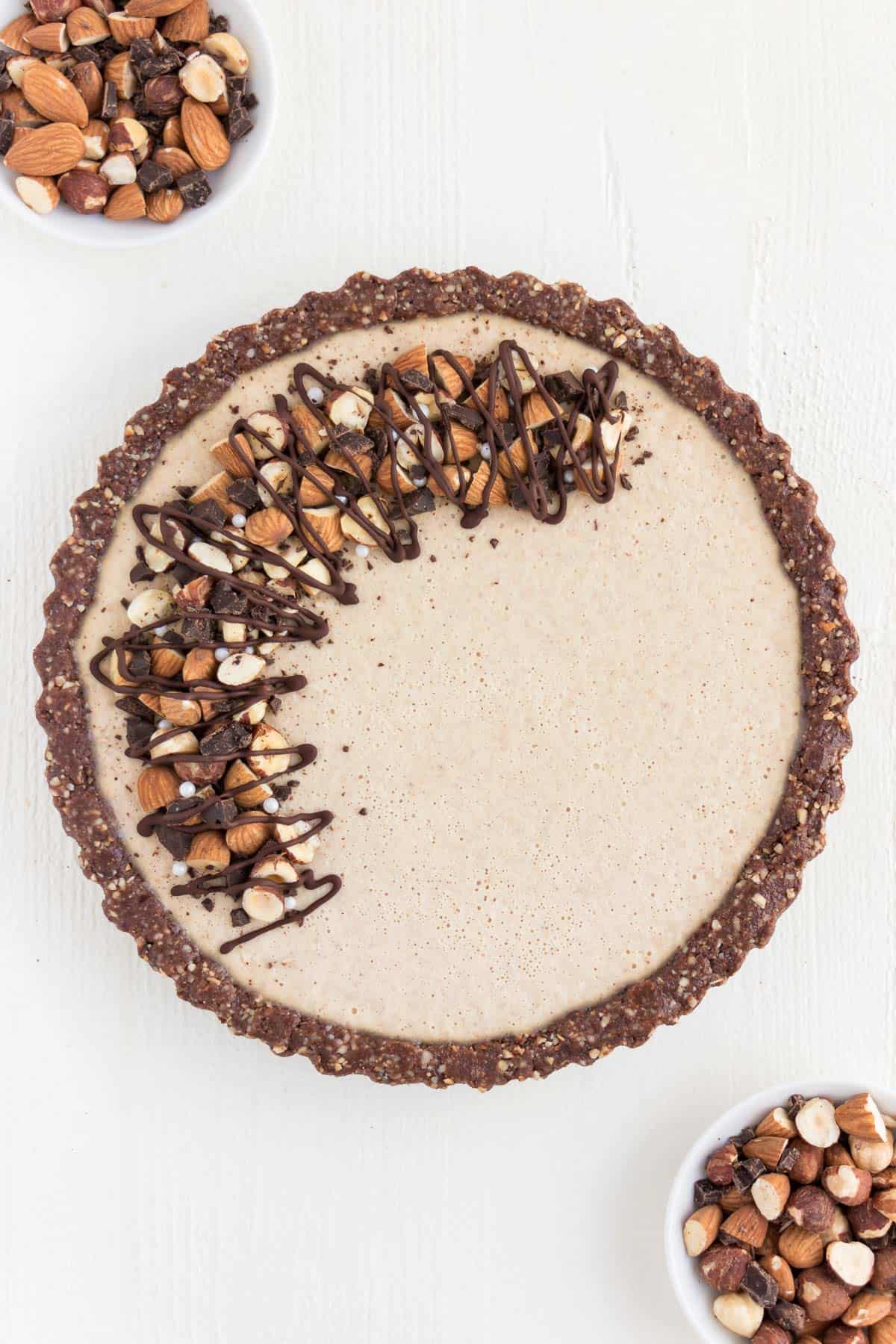 no bake chocolate almond cheesecake topped with chocolate and nuts