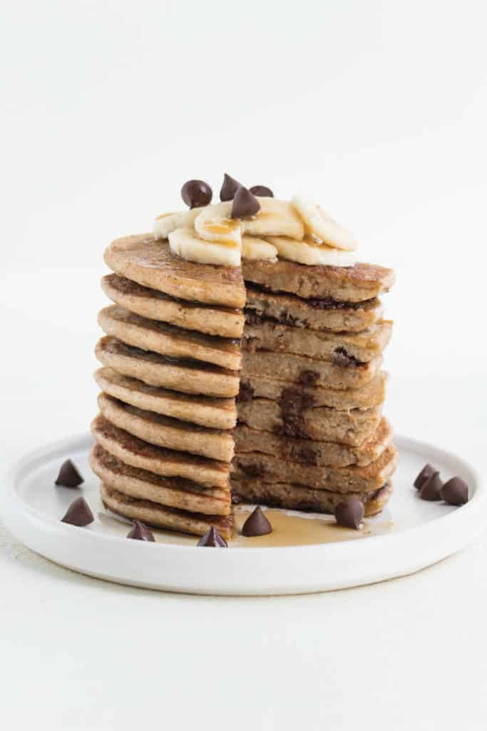 a sliced stack of banana pancakes with chocolate chips and banana