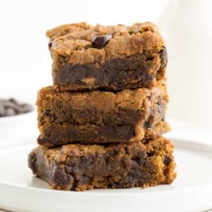 chocolate chip pumpkin bars stacked on a white plate