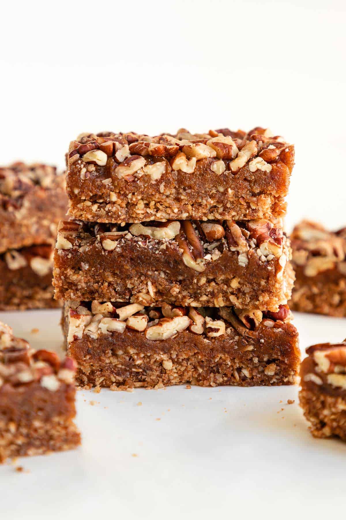 a stack of three pecan pie bars on top of a white marble surface