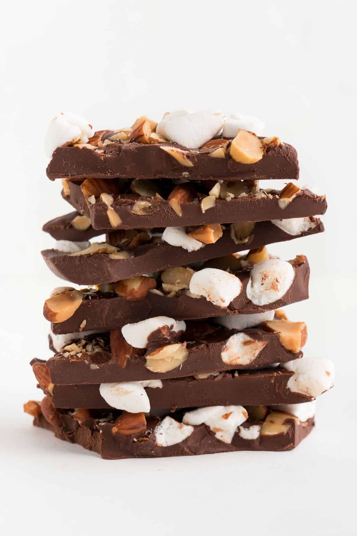 a tall stack of rocky road chocolate bark with marshmallows and almonds