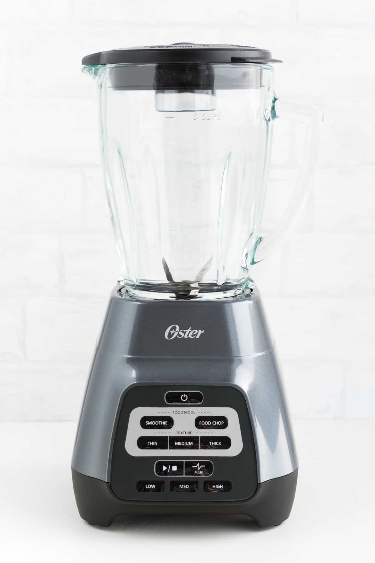 oster texture select master series blender in front of a white tile wall