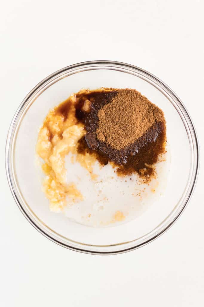 mashed banana, coconut sugar, and almond milk in a glass bowl