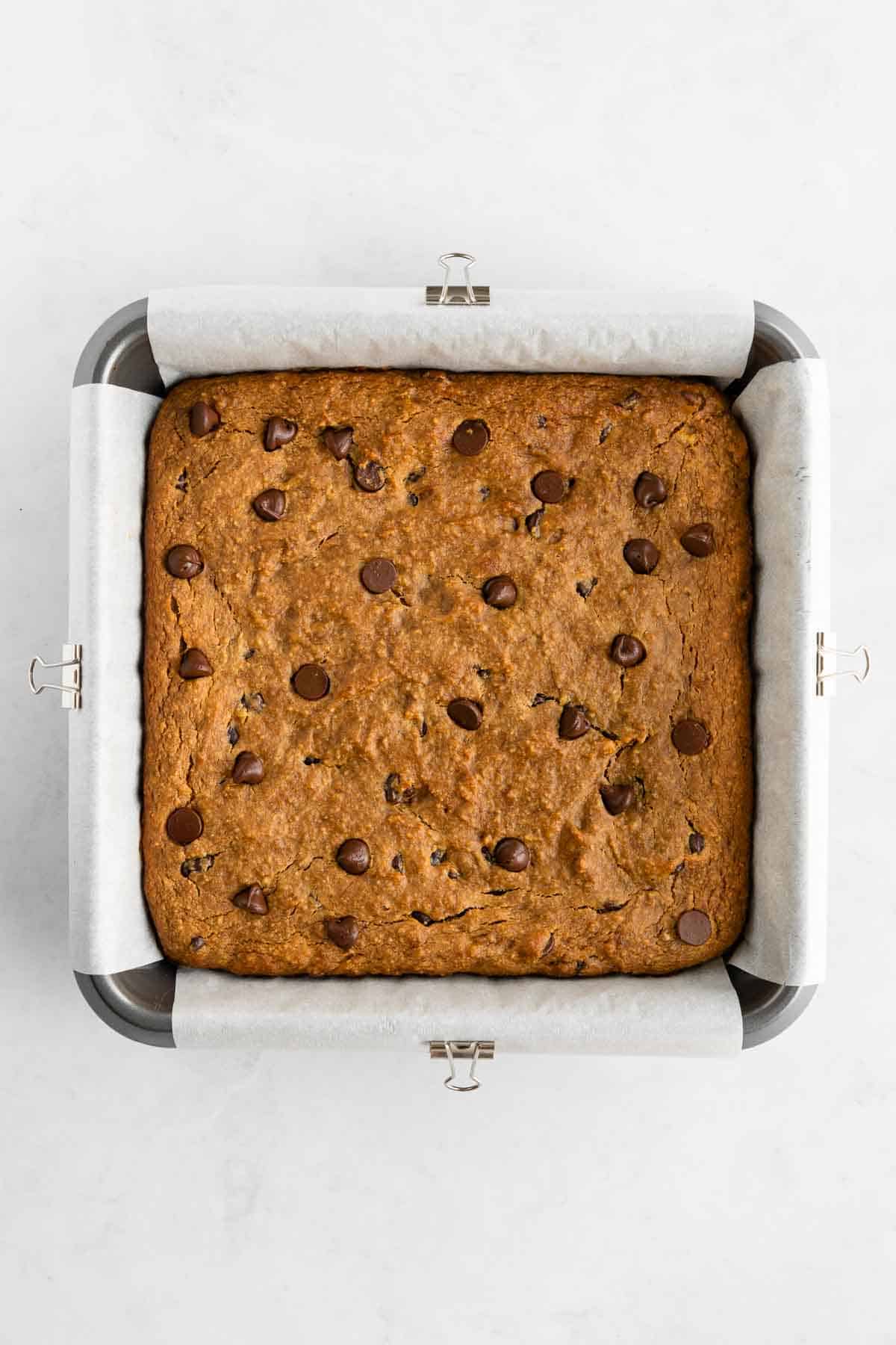 baked healthy banana bars with chocolate chips in a square baking dish