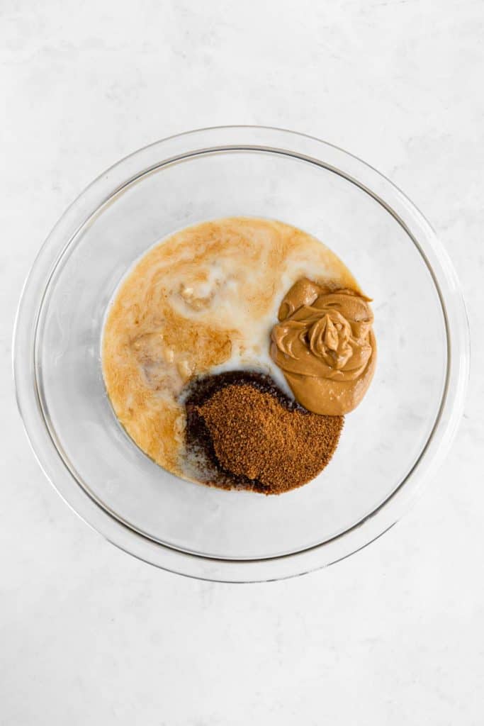 mashed banana, peanut butter, coconut sugar, and almond milk in a glass bowl