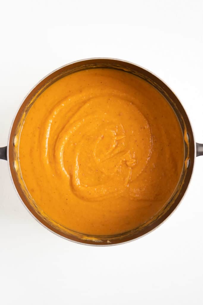 creamy vegan sweet potato soup inside a black sauce pot