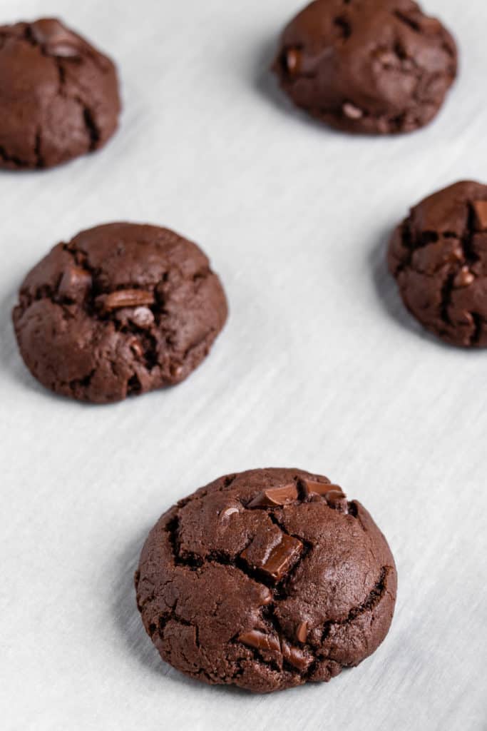 vegan double chocolate chunk cookies on a baking sheet