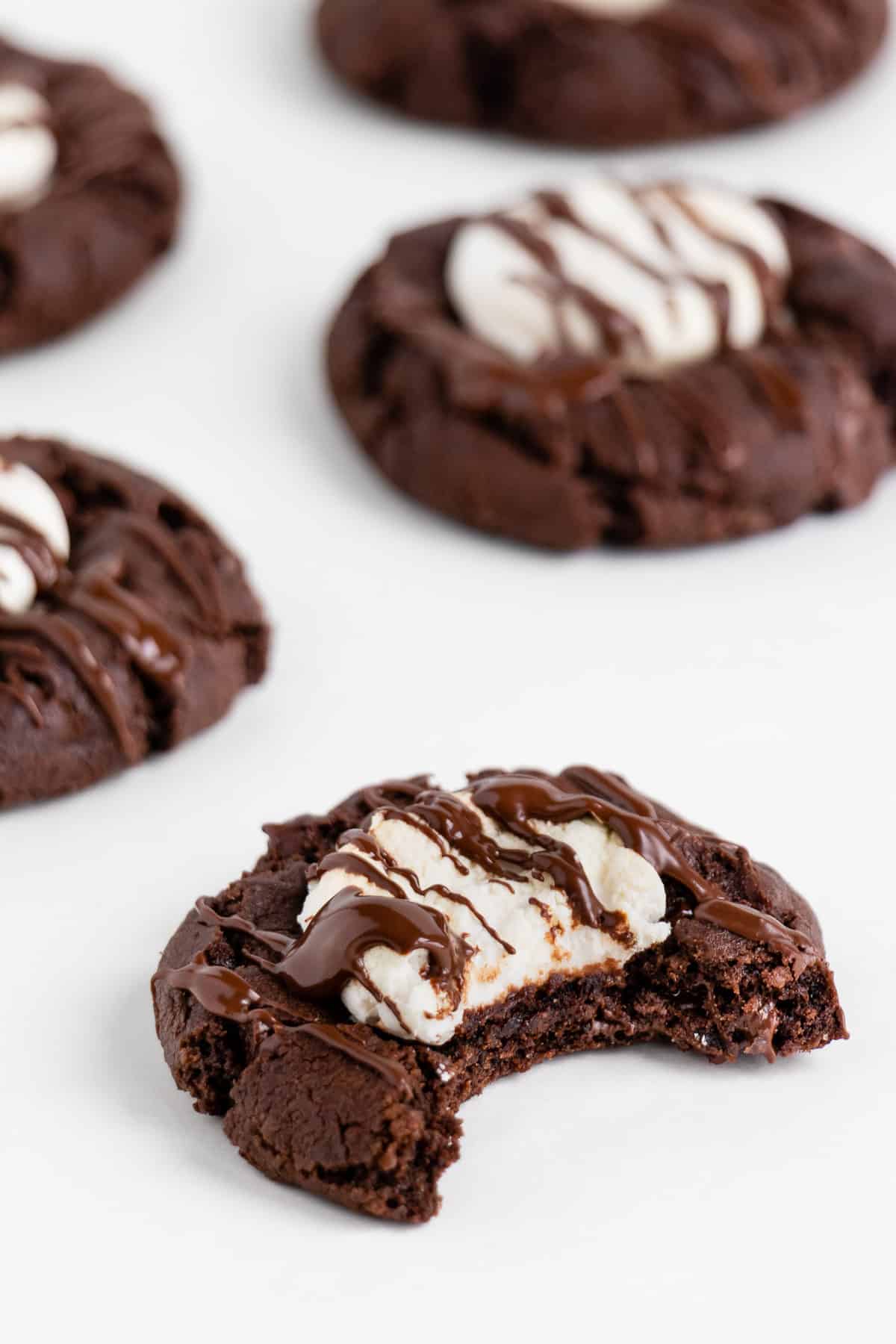 a bite taken out of a vegan hot cocoa marshmallow cookie