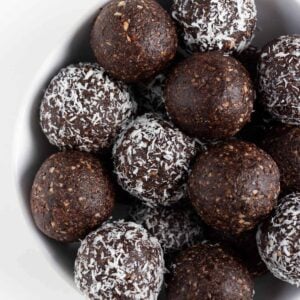 chocolate coconut energy balls inside a white bowl