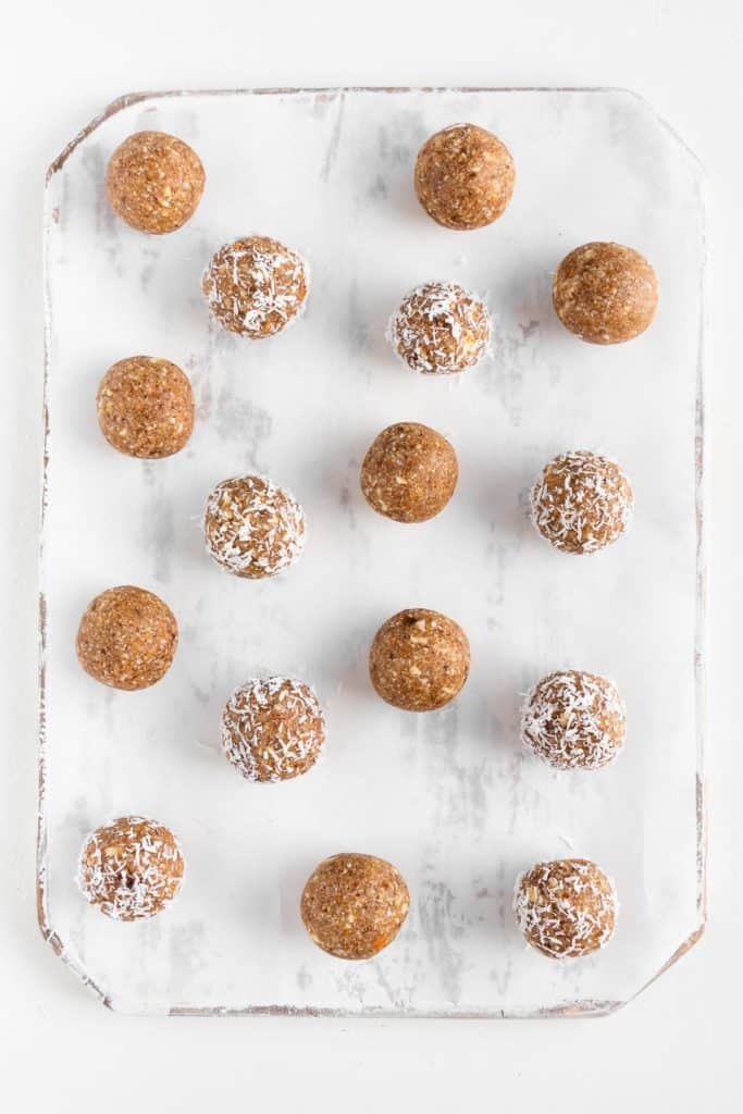 energy balls on a white distressed cutting board