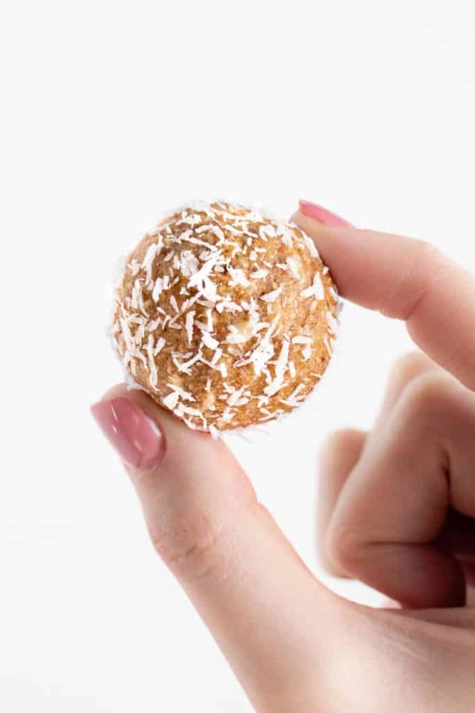 hand holding a coconut almond bliss balls