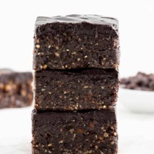 a stack of three no bake vegan brownies with chocolate ganache