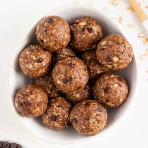 a stack of oatmeal cookie dough balls stacked in a white bowl