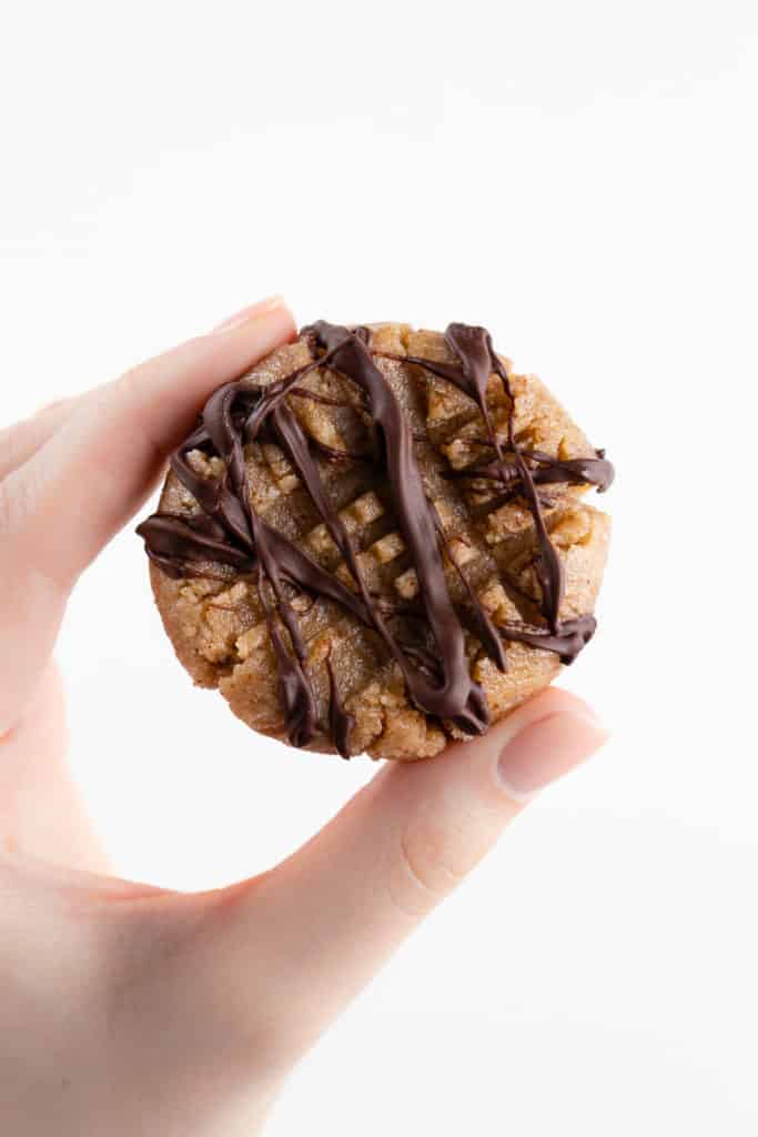 hand holding a no bake almond butter cookie