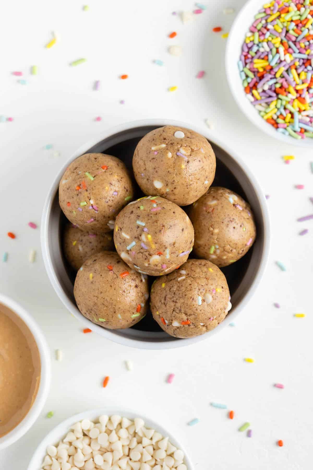 a bowl filled with birthday cake energy balls