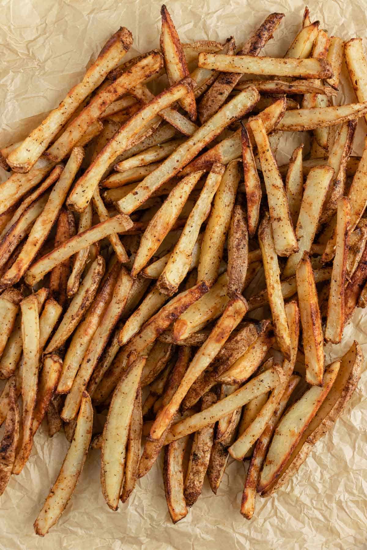 crispy baked french fries on brown parchment paper