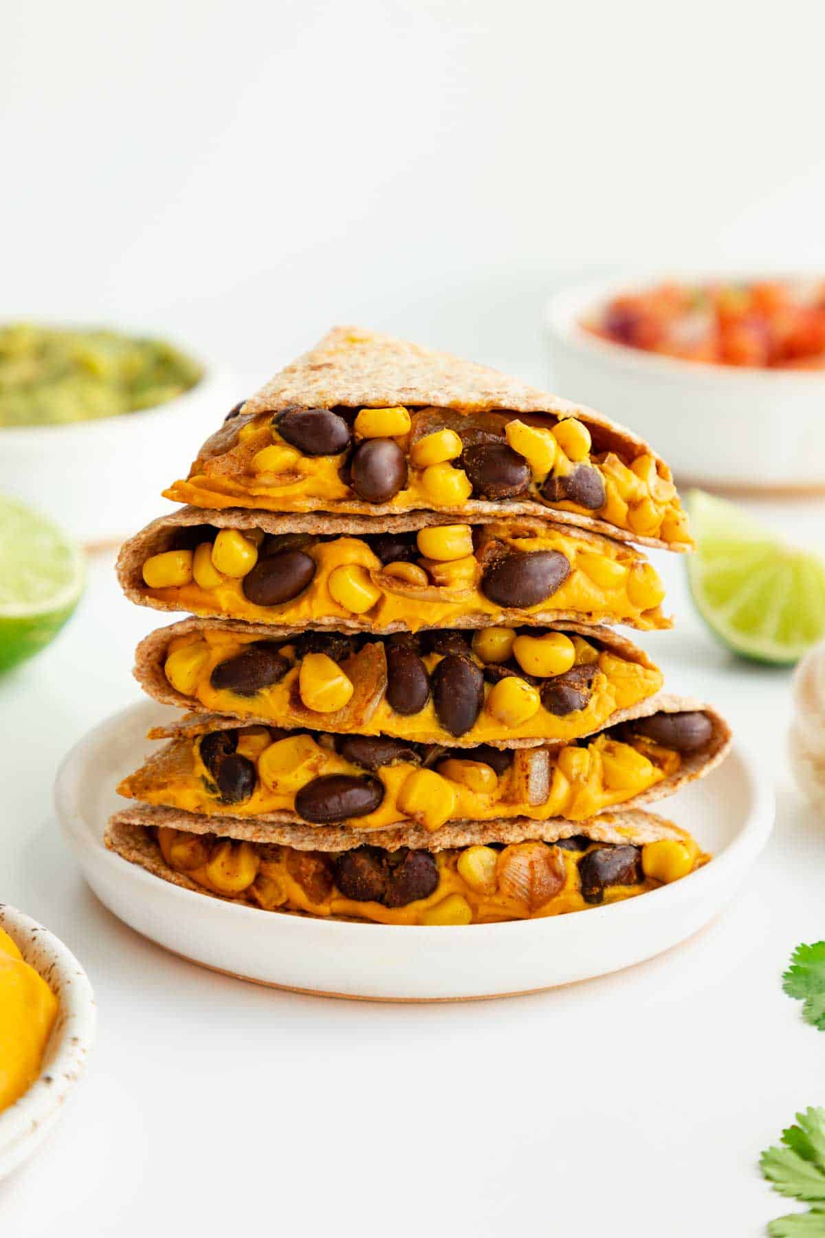 vegan quesadillas with sweet potatoes and black beans on a white plate