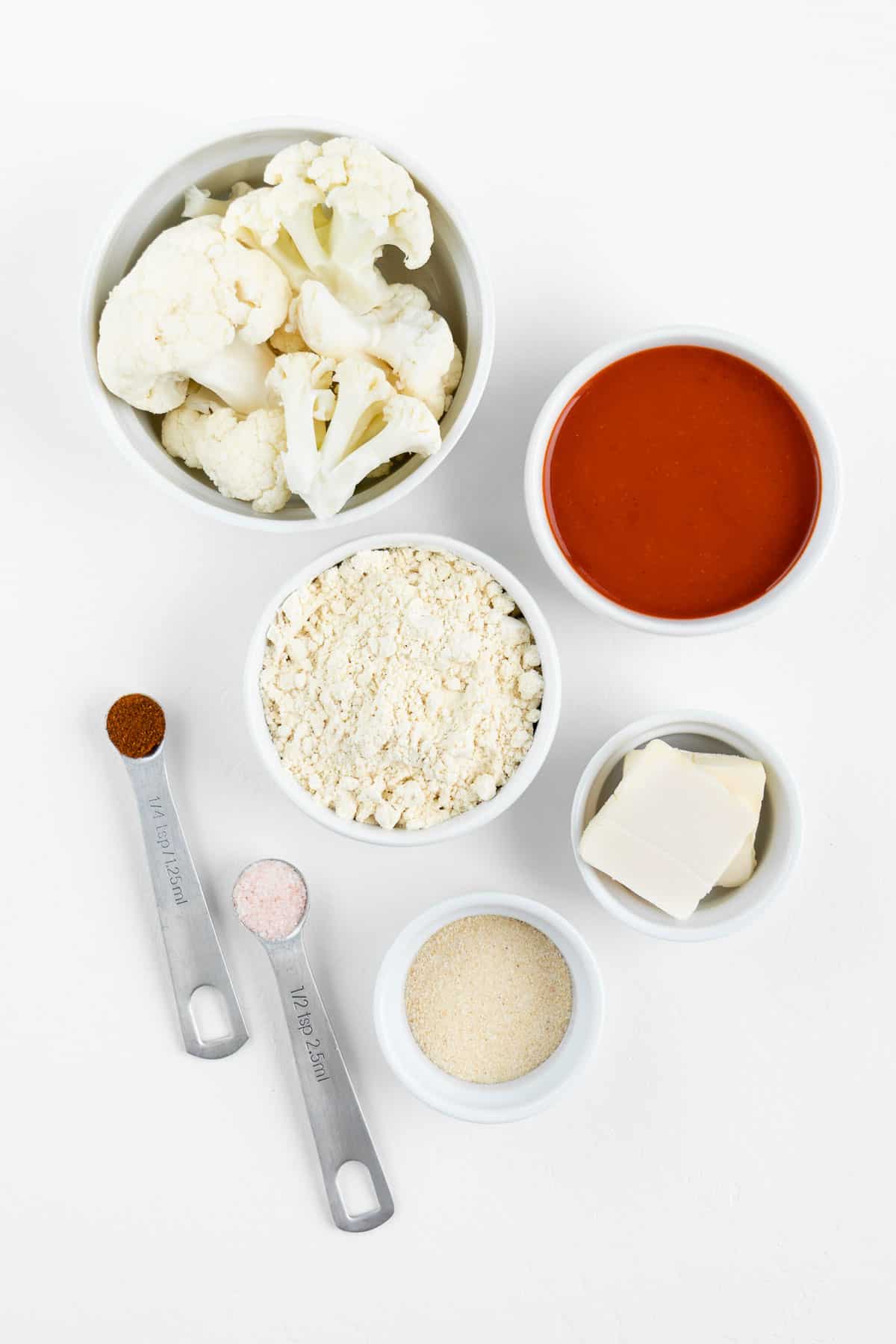 flour, hot sauce, vegan butter, garlic, salt, and smoked paprika inside white bowls
