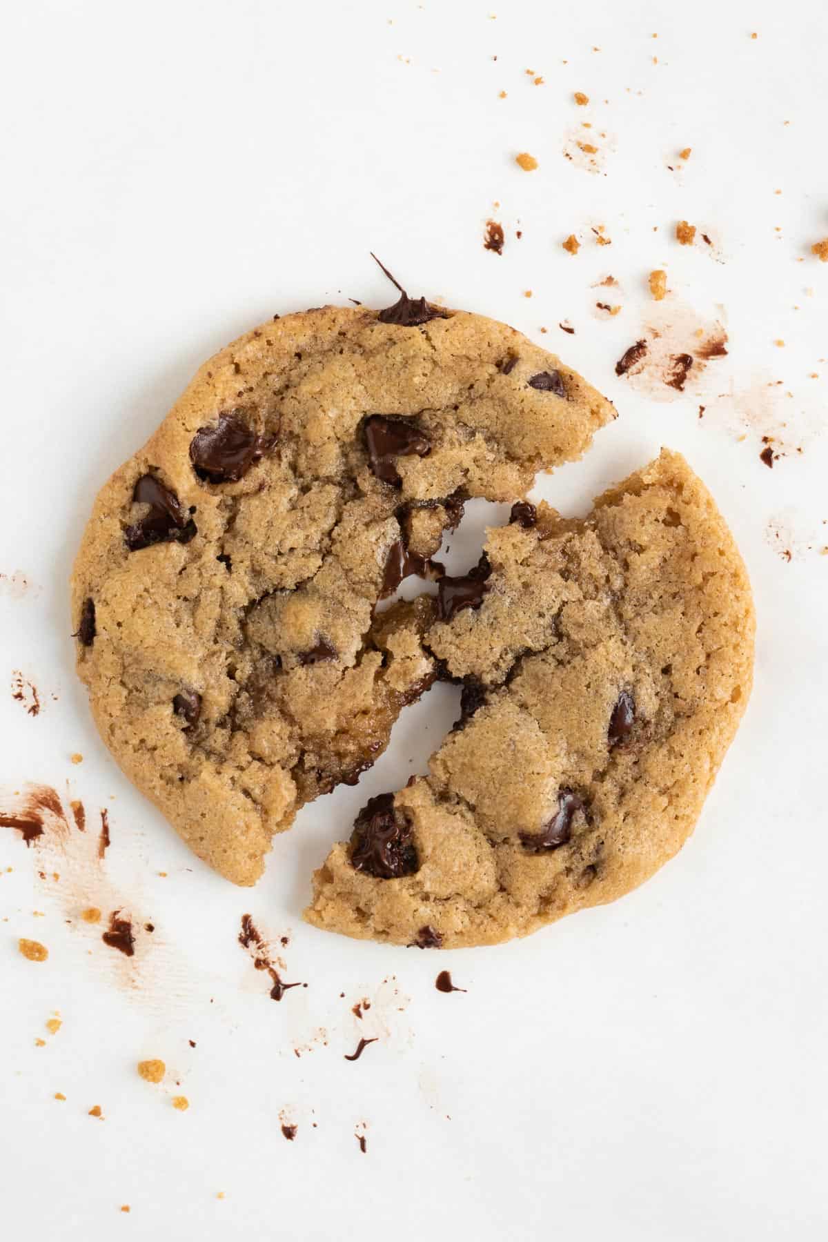 a gooey vegan chocolate chip cookies pulled apart