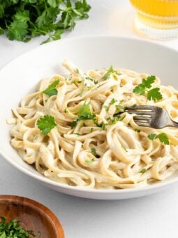 vegan fettuccine alfredo inside a white bowl