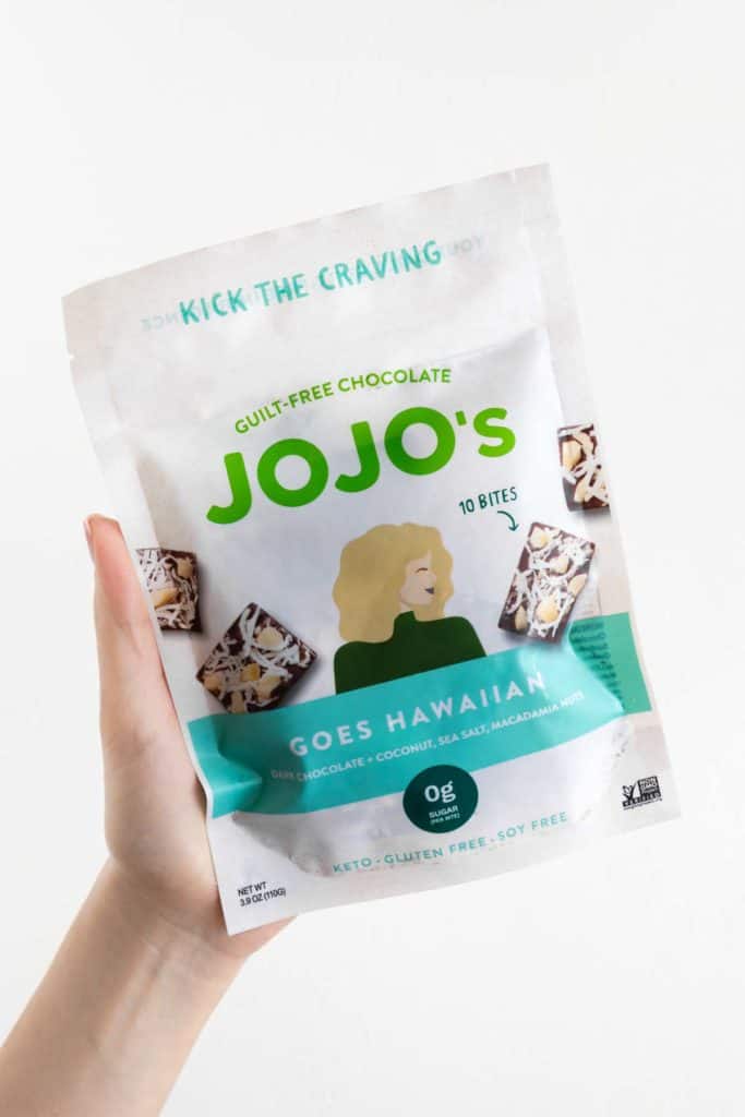 a hand holding a bag of jojo's goes hawaiian chocolate bites