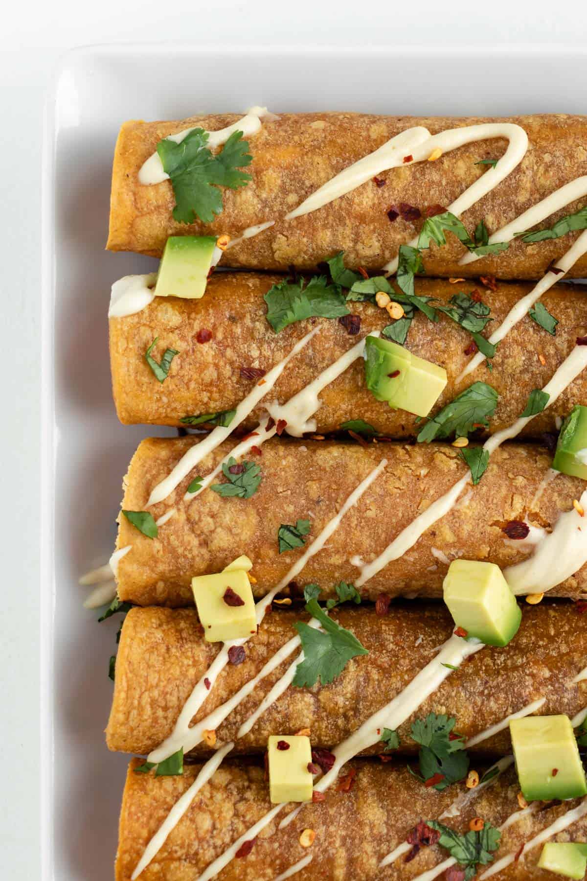 corn tortilla taquitos stuffed with sweet potato and black beans