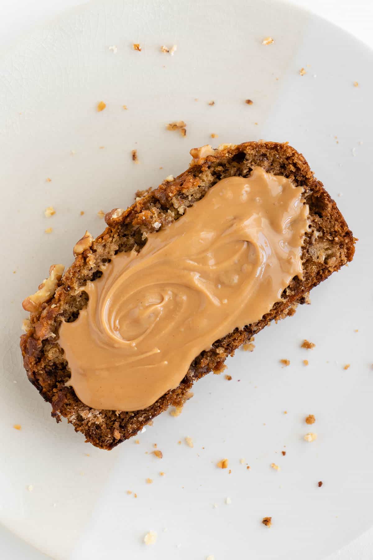 a slice of banana bread with peanut butter spread on top of it