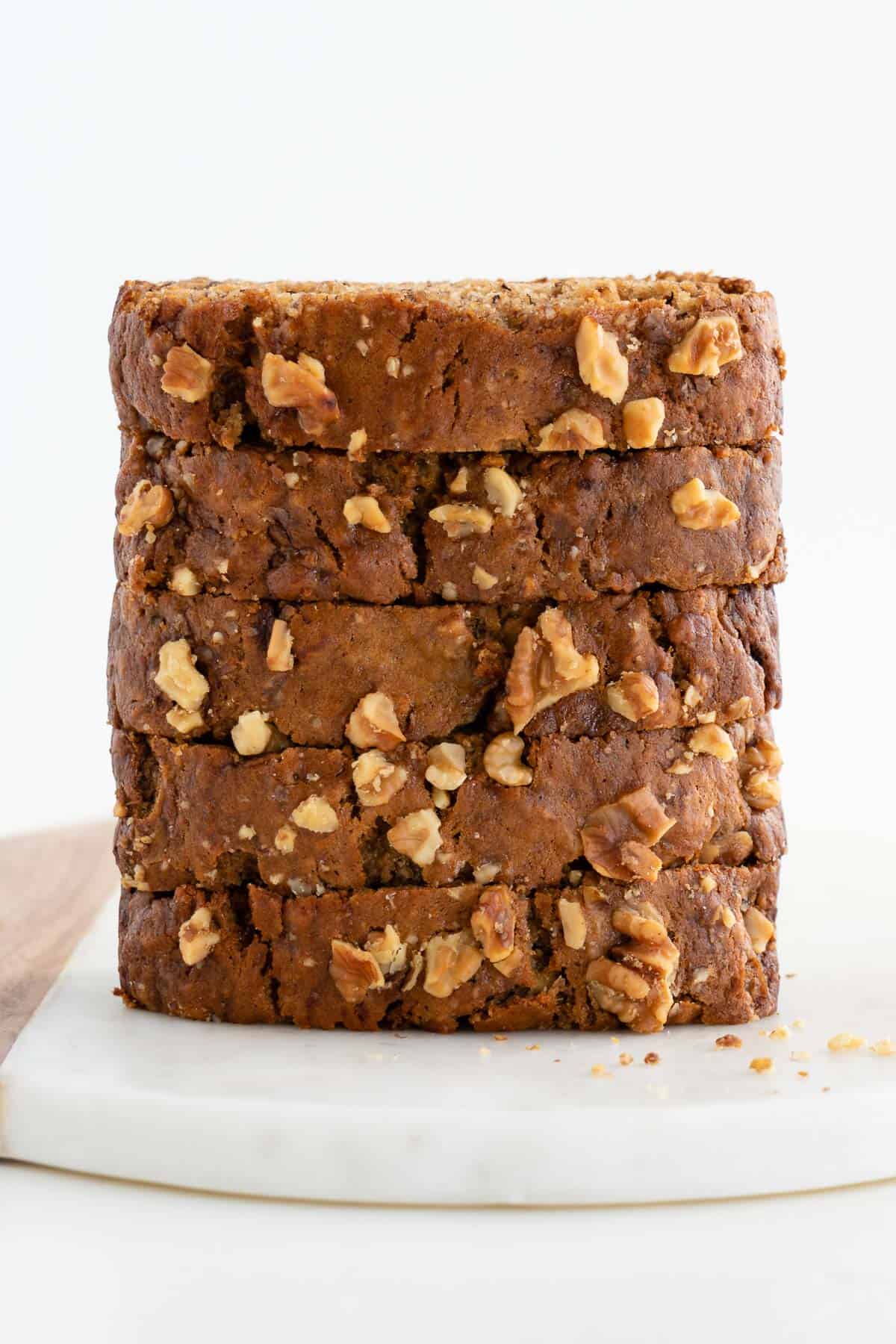 a stack of vegan banana bread slices with walnuts