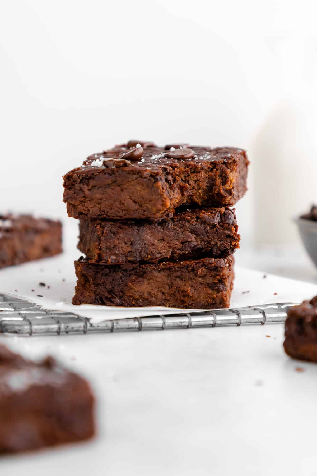 vegan protein brownies sliced into squares on white parchment paper