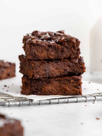 a stack of three flourless vegan protein brownies with chocolate chips