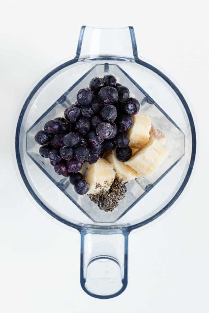 bananas, berries, and chia seeds inside a vitamix blender