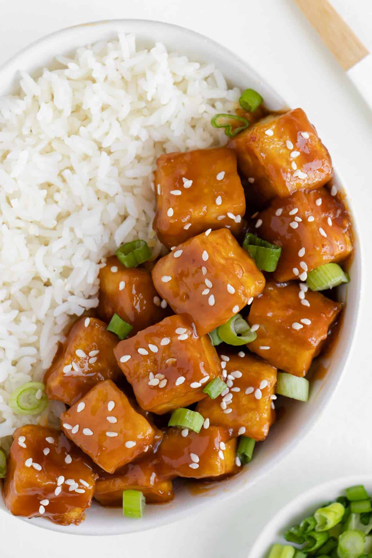 vegan orange tofu in a bowl with white rice