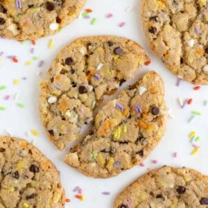 five vegan funfetti birthday cookies surrounded by rainbow sprinkles