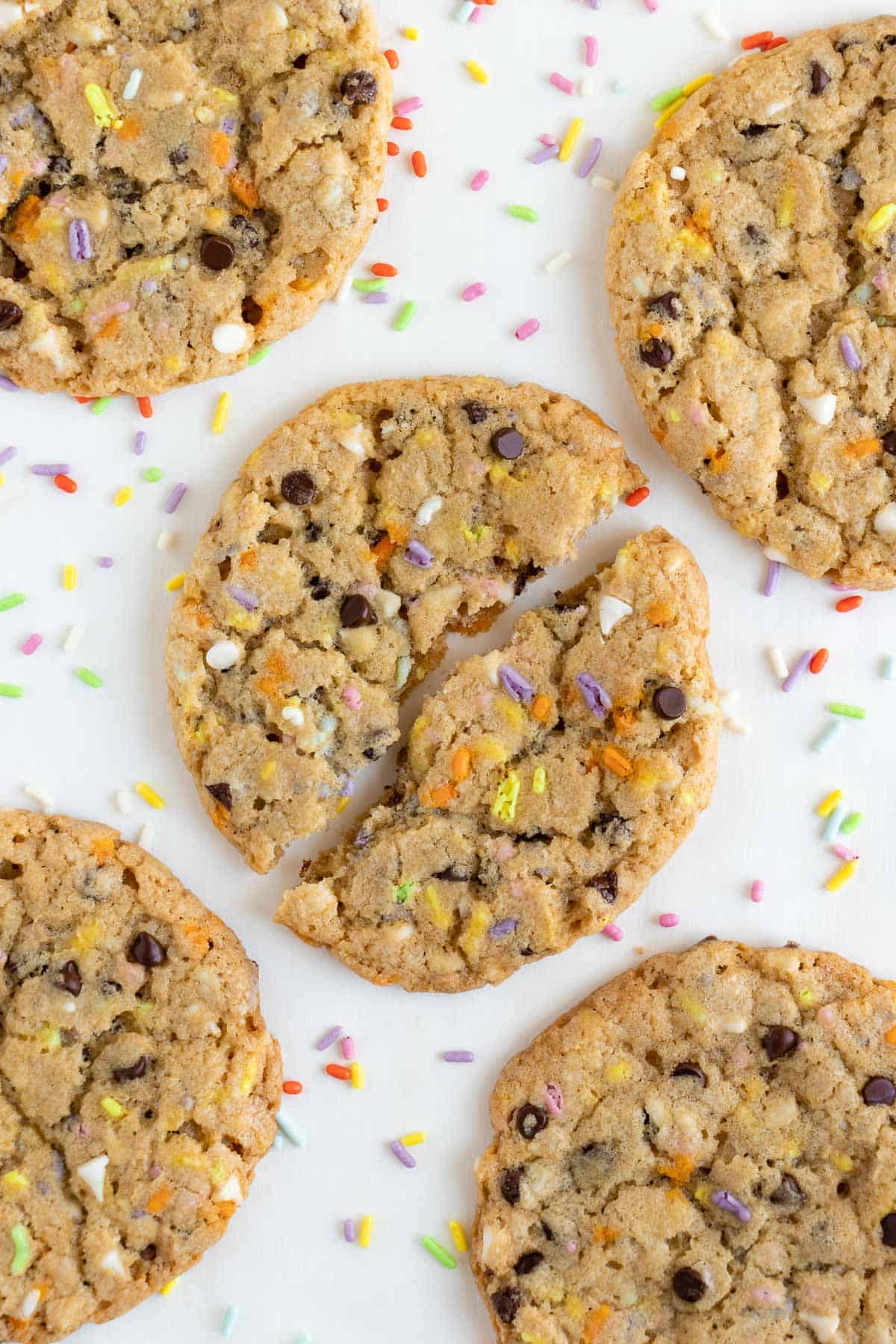 five vegan funfetti birthday cookies surrounded by rainbow sprinkles