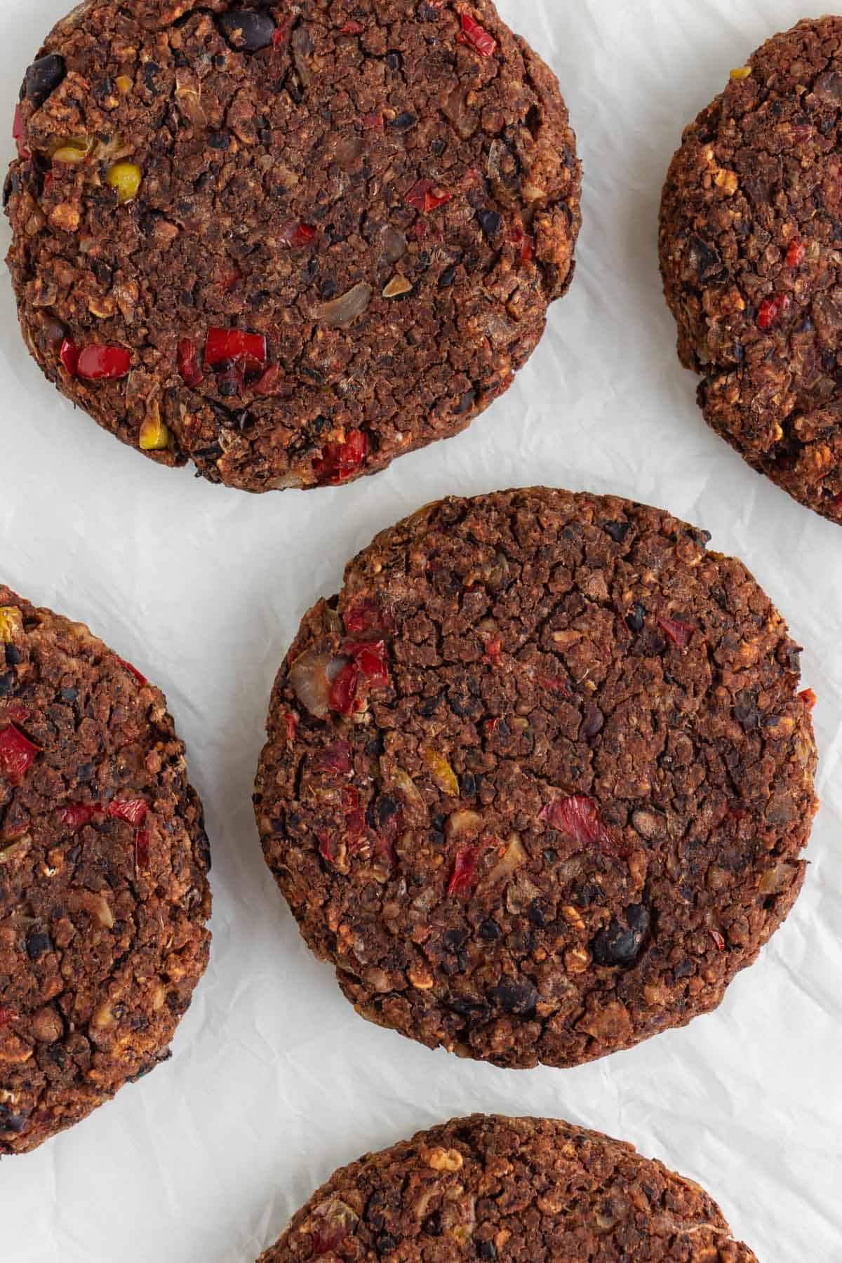 vegan black bean burger patties on white parchment paper