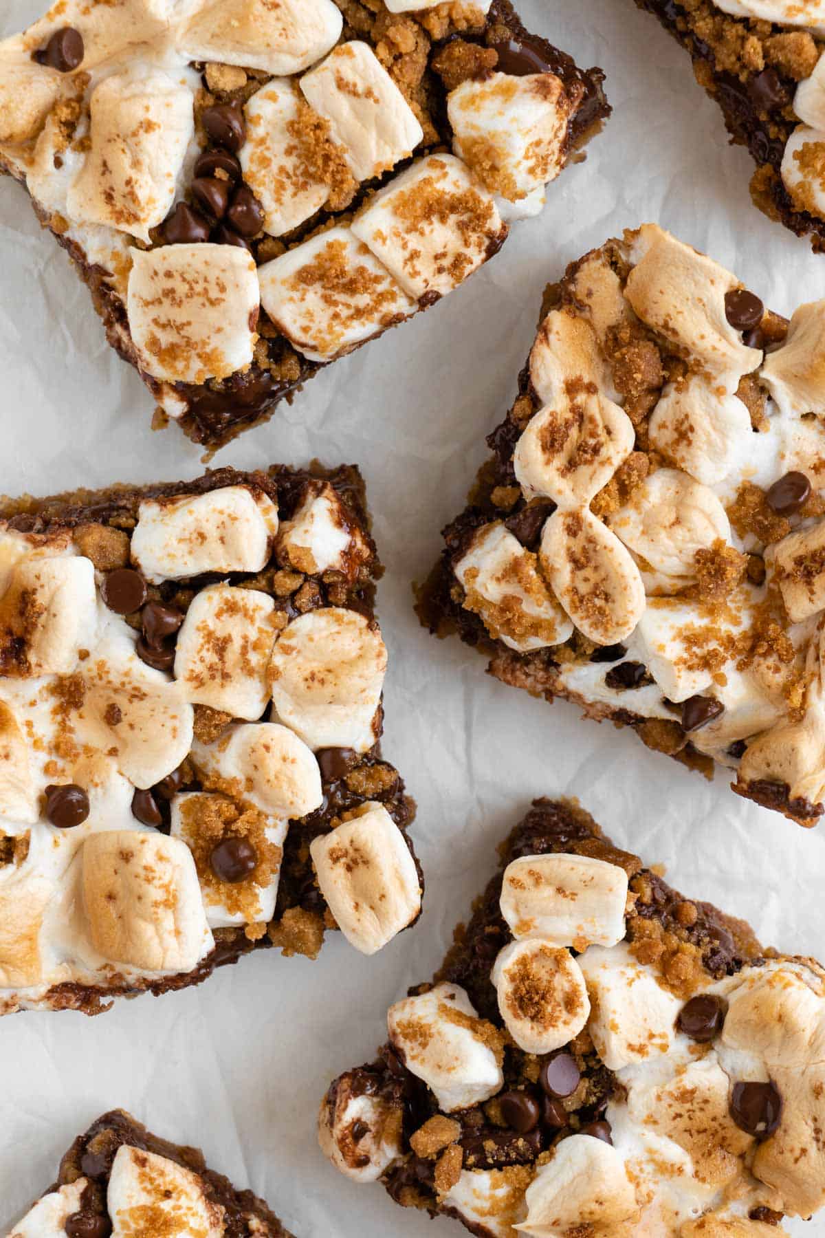 a close-up of vegan s'mores bars on a sheet of white parchment paper
