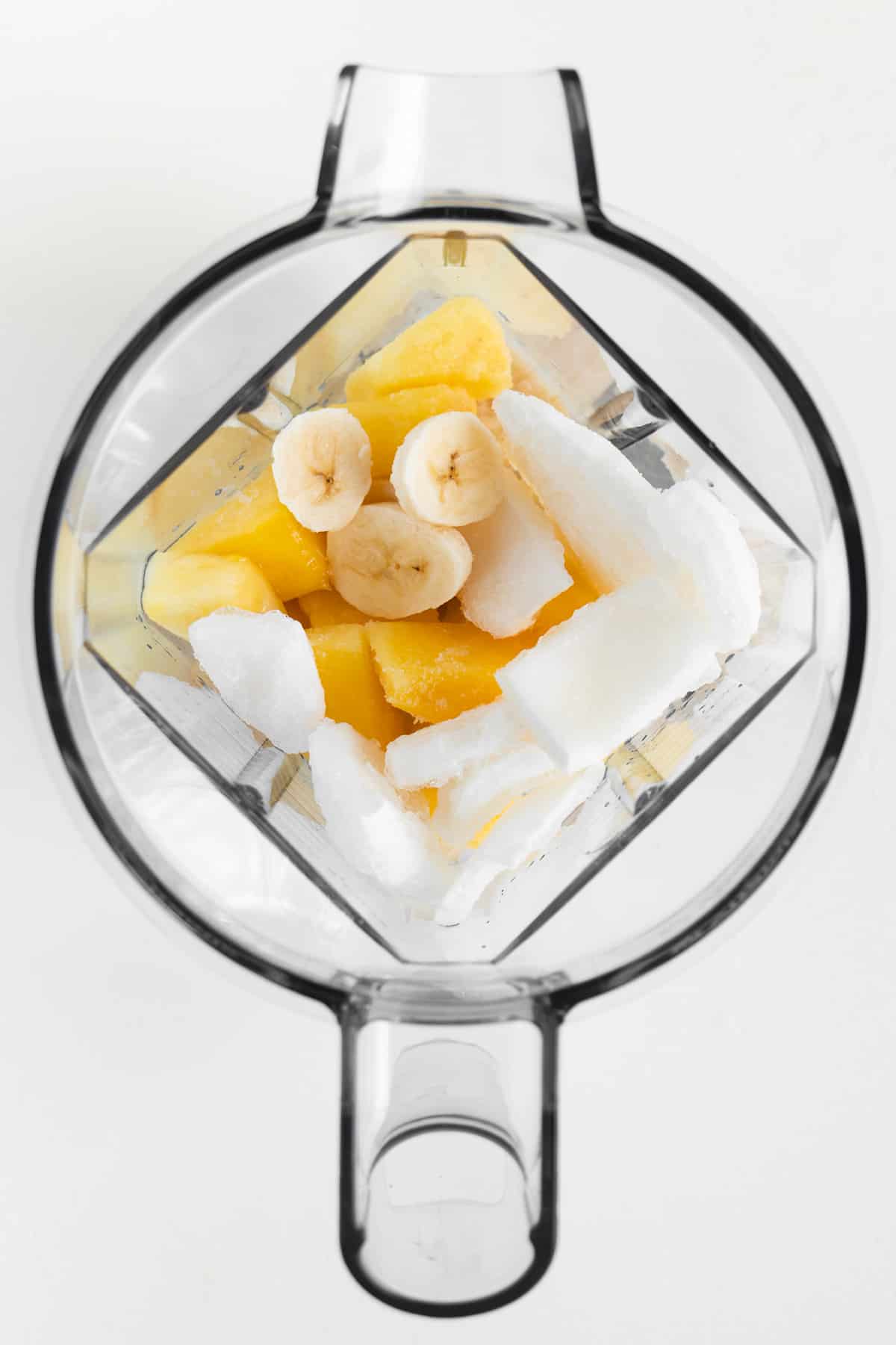 bananas, coconut, and pineapple inside a blender