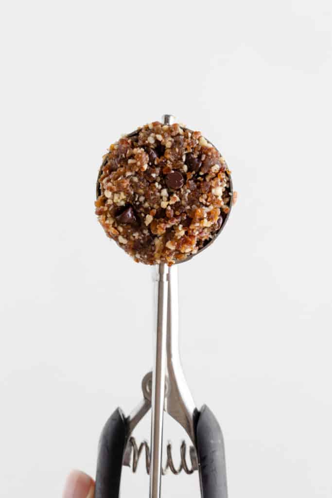 no bake pecan and date dough inside a mini cookie scoop
