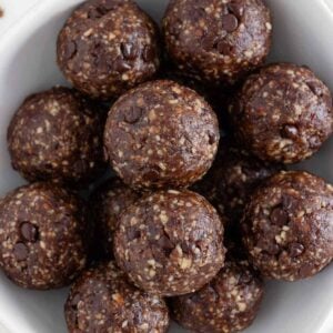 chocolate turtle energy balls inside a white bowl