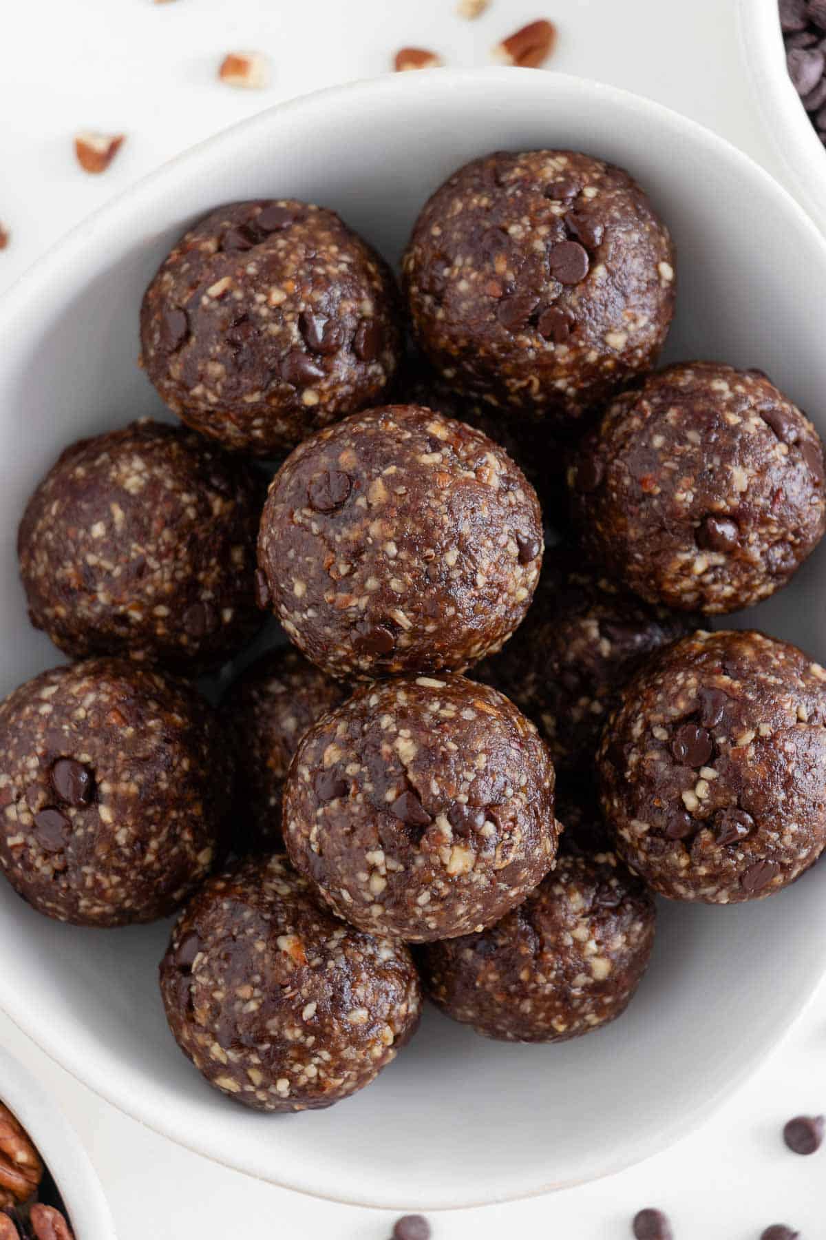 chocolate turtle energy balls inside a white bowl