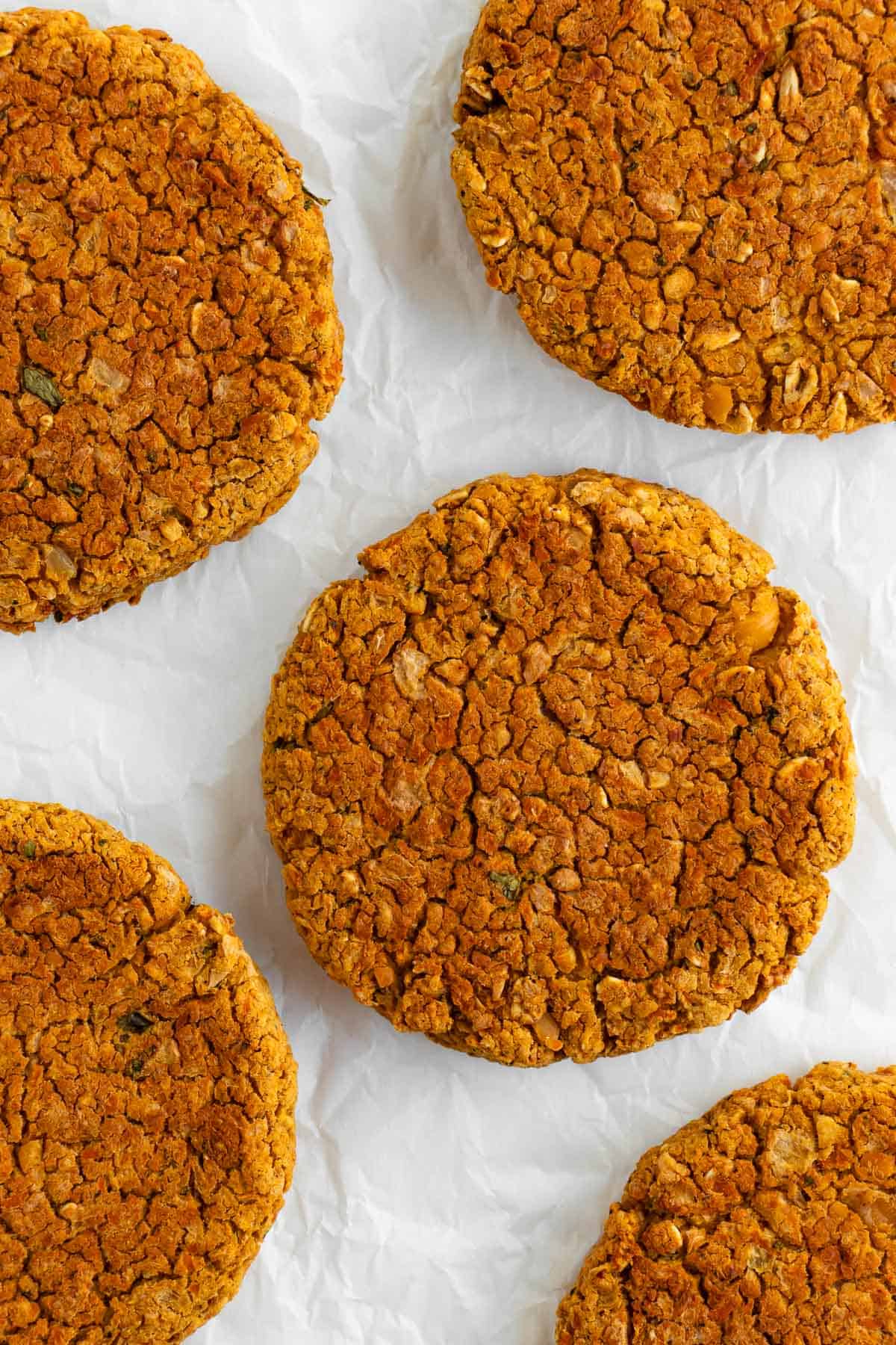 vegan chickpea burger patties on white parchment paper