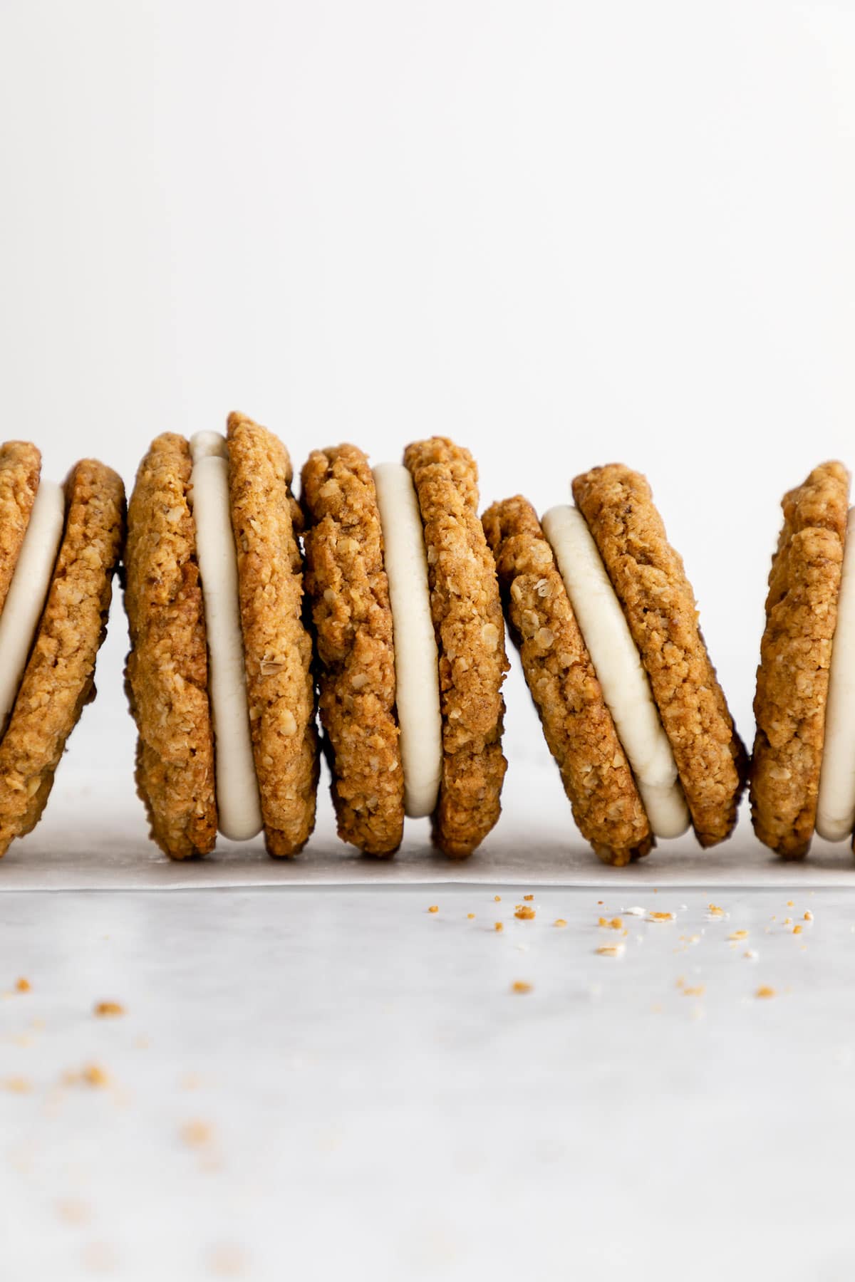 a row of vegan oatmeal cream pie cookie sandwiches