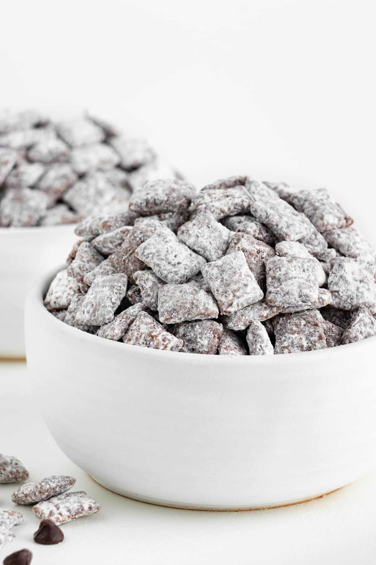 two white bowls filled with vegan muddy buddies